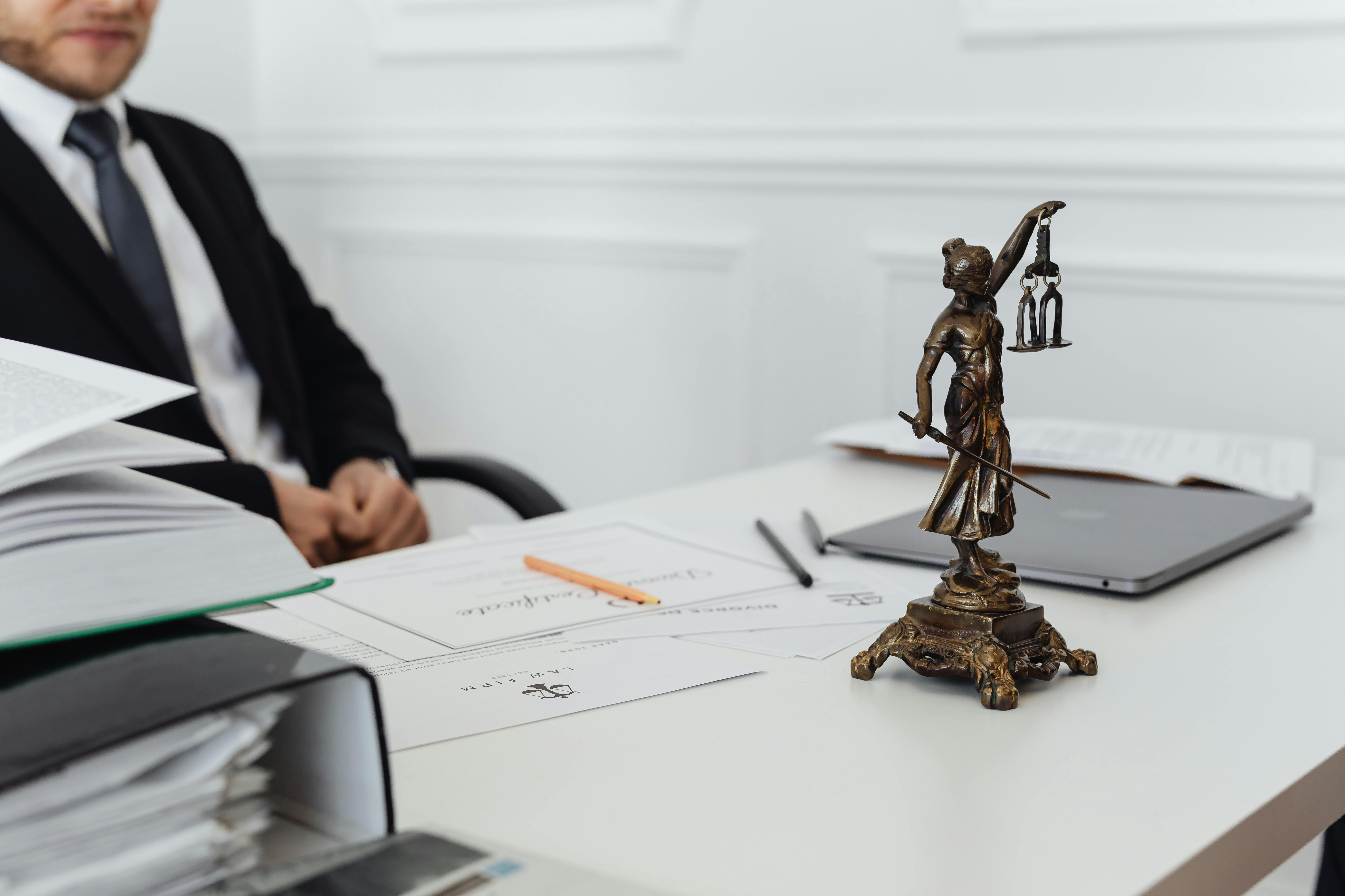 Lawyer sitting at his desk overwhelmed by manual paperwork. 